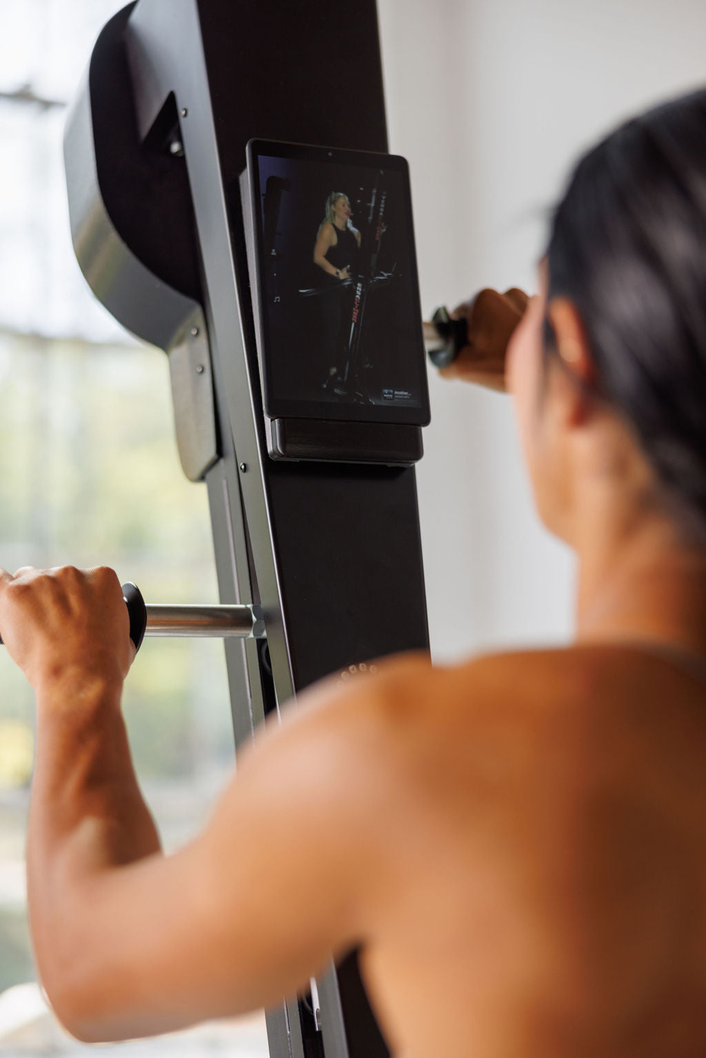 Over-the-shoulder view of the VersaClimber TS-M touchscreen in use