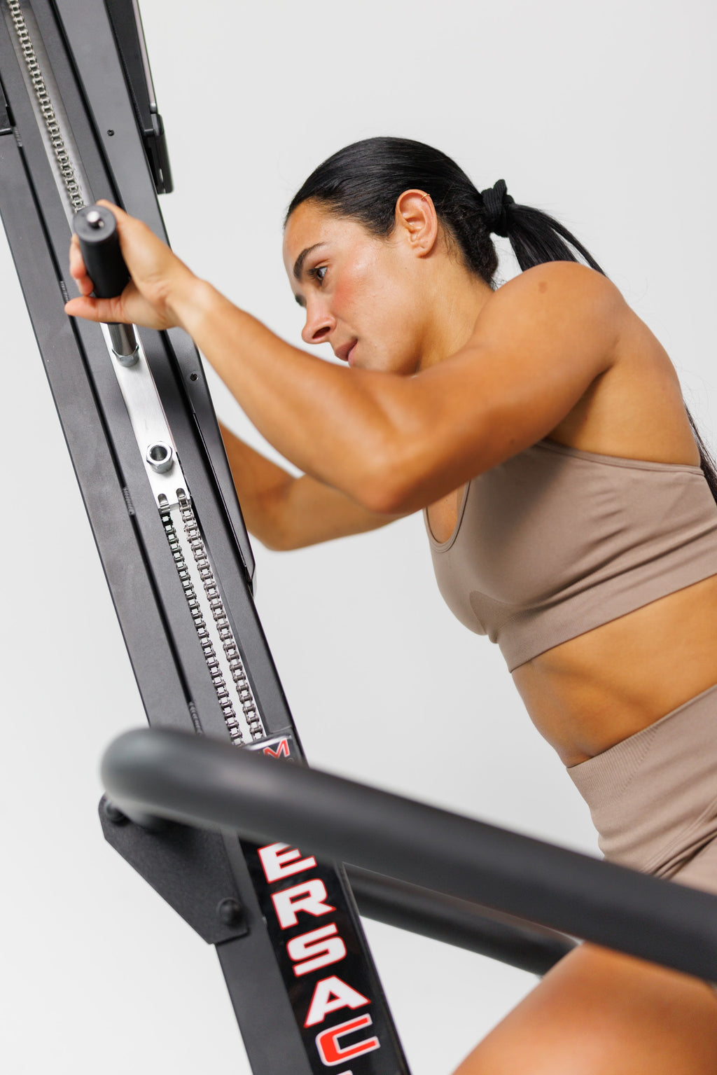 Woman mid-climb on a VersaClimber TS-M, close up