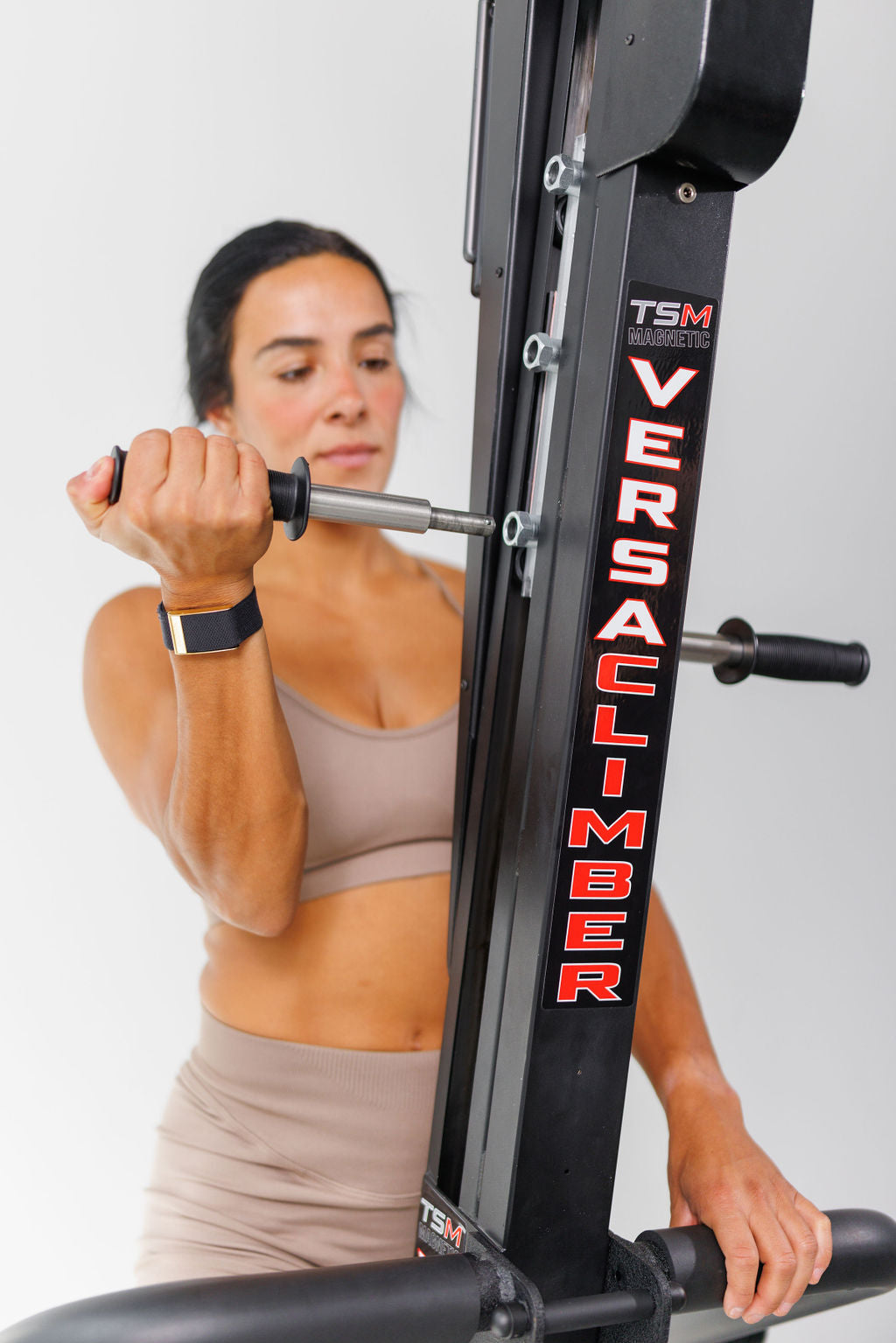 Gripping the VersaClimber handle mid-climb